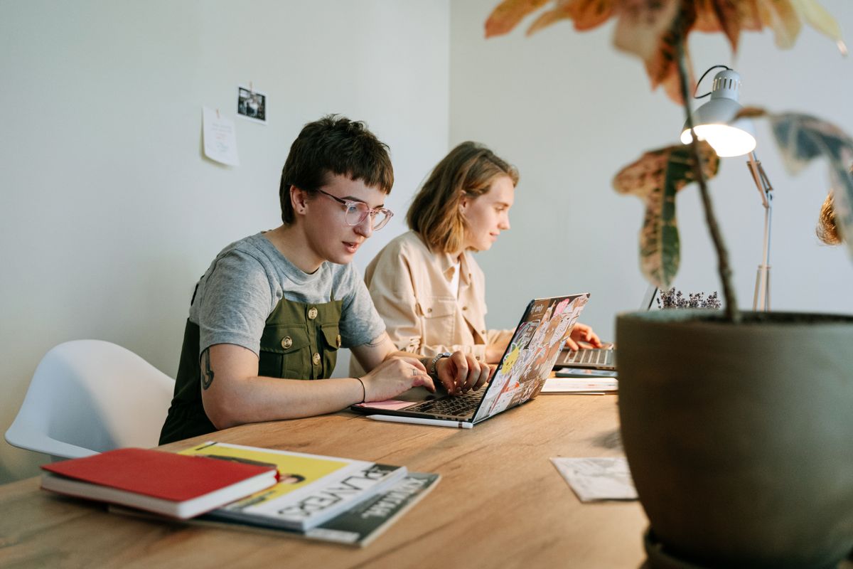Two people working online together on a laptop